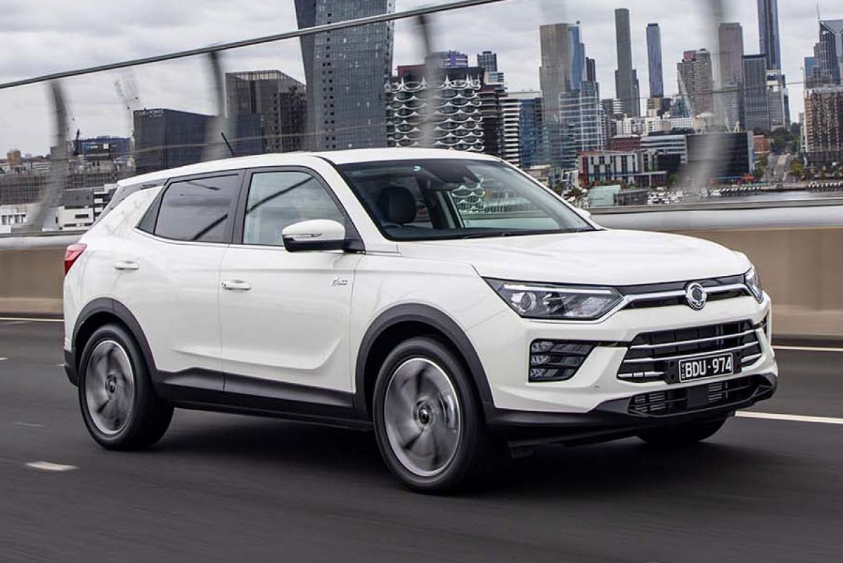 Front side view of a white SsangYong Korando Ultimate 2020 car driving down a freeway