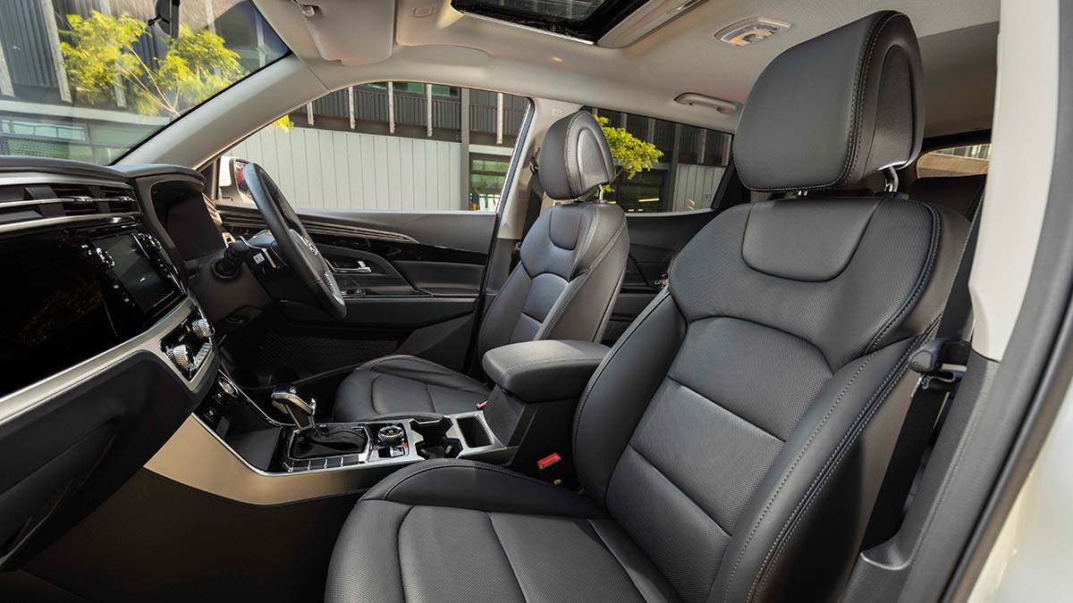 Dark grey interior of the SsangYong Korando Ultimate 2020 showing the front seats, centre console and steering wheel