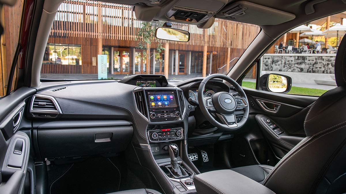 Dark grey interior of the Subaru Forester Hybrid S 2020 showing the dashboard and steering wheel