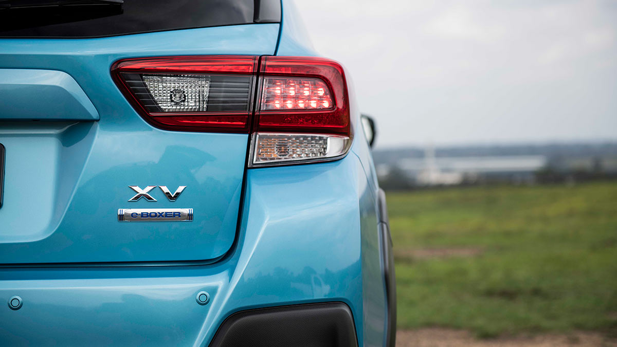 Close up of the XV and e-BOXER badge and tail light on the rear of a light blue Subaru XV Hybrid 2020 car