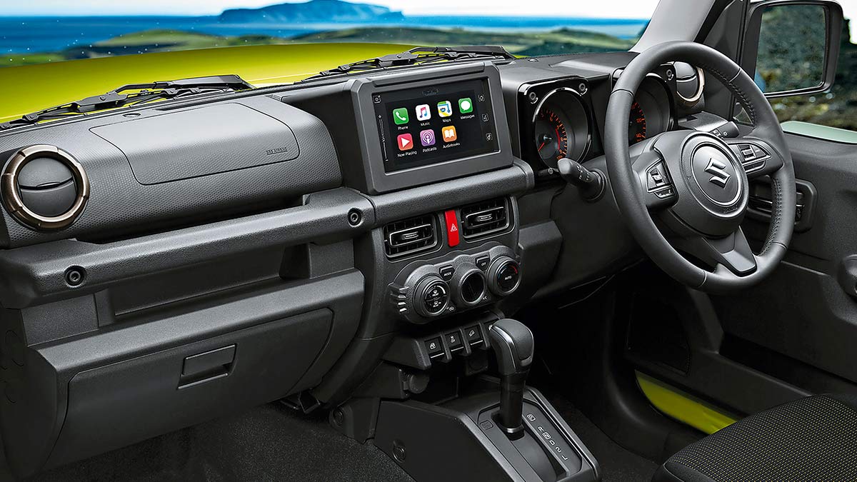 Dark grey interior of the Suzuki Jimny 2019 showing the dashboard, centre console and steering wheel