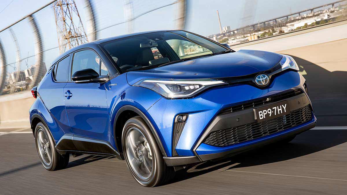 Front angle view of a blue Toyota C-HR Hybrid in motion