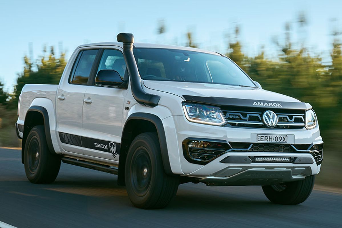 A white Volkswagen Amarok W580X drives on the road.