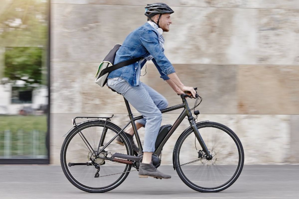 young man riding his bike to work