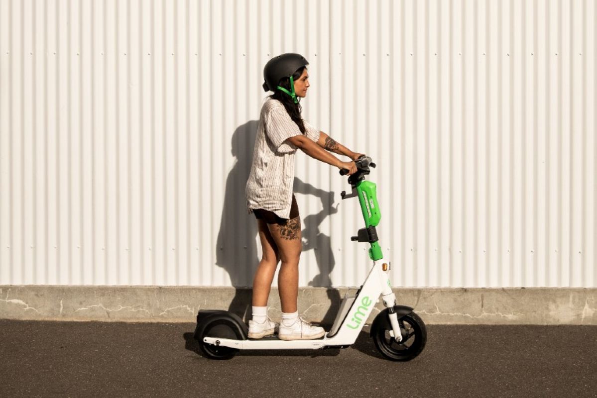 person riding a Lime e-scooter in Melboourne