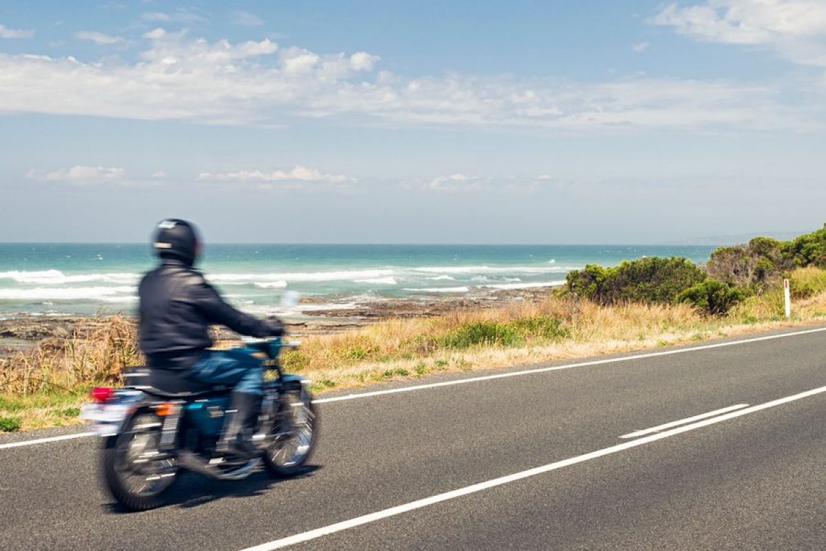 A person riding a motorbike on the Great Ocean Road