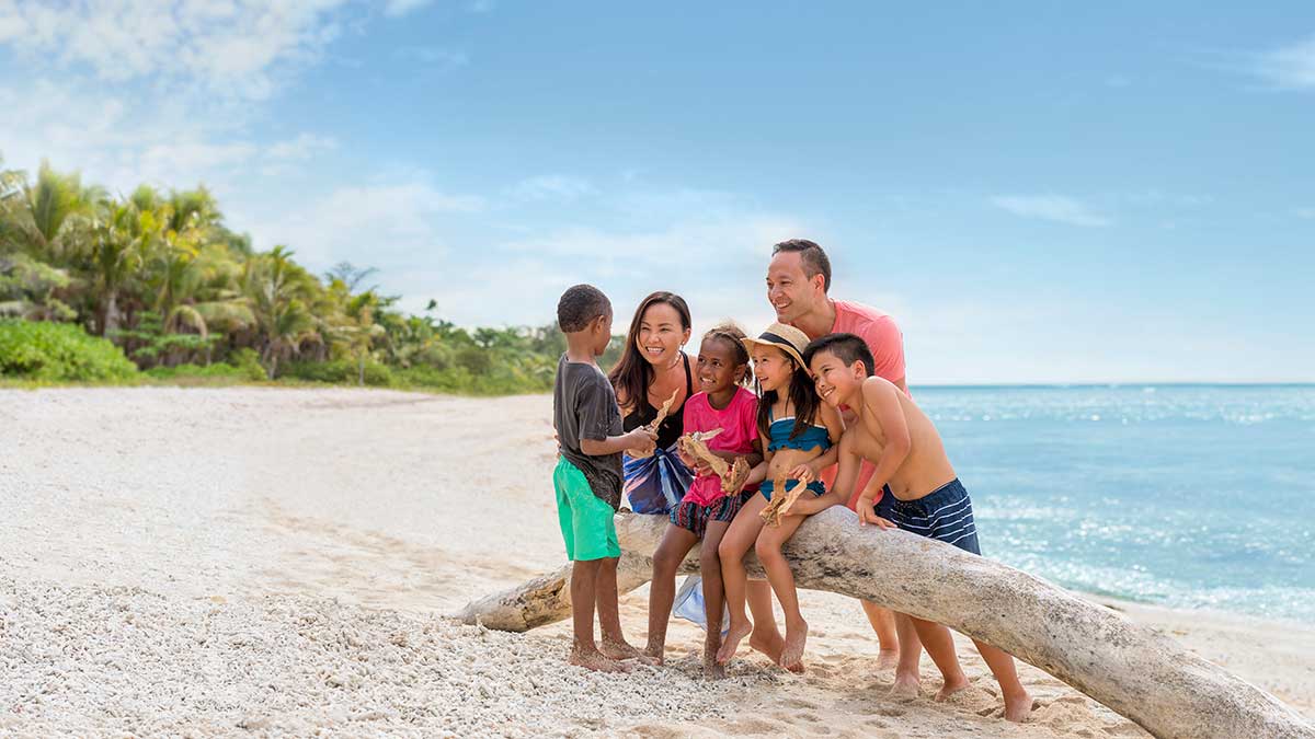 family sitting on branch taking a selfie