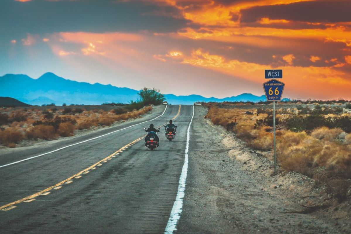 Motorbikes driving towards horizon