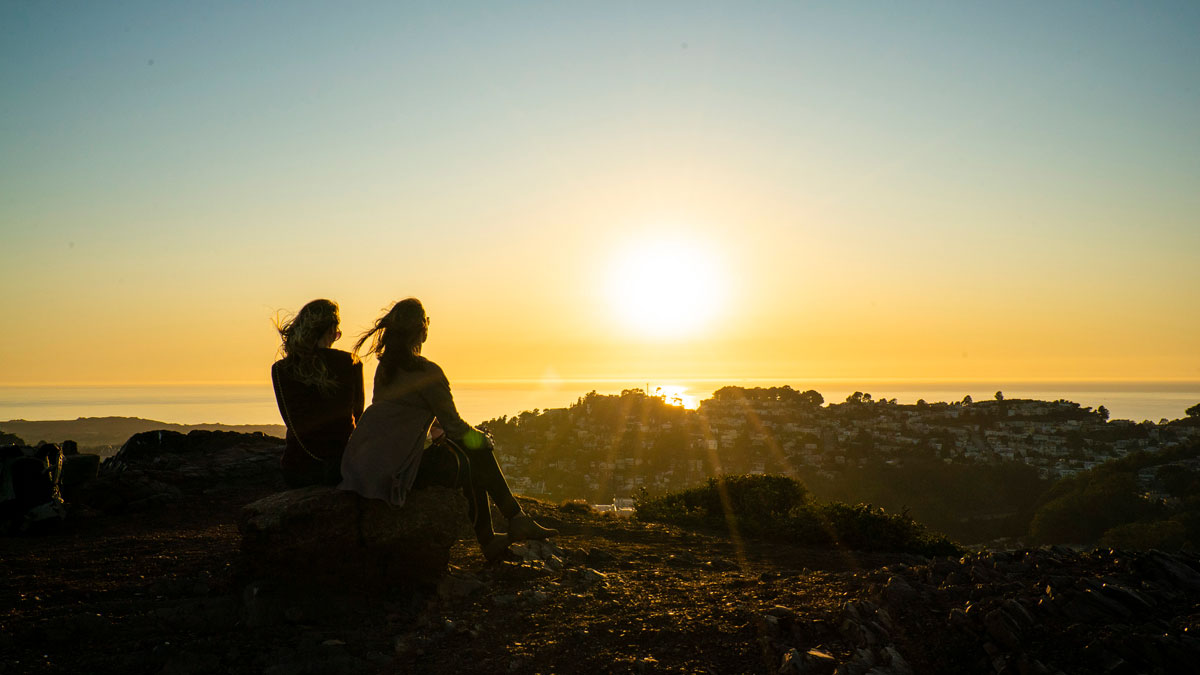 Two people at the top of Twin Peaks in San Francisco