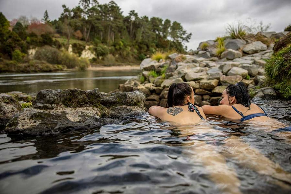 Two people bathing in a rockpool