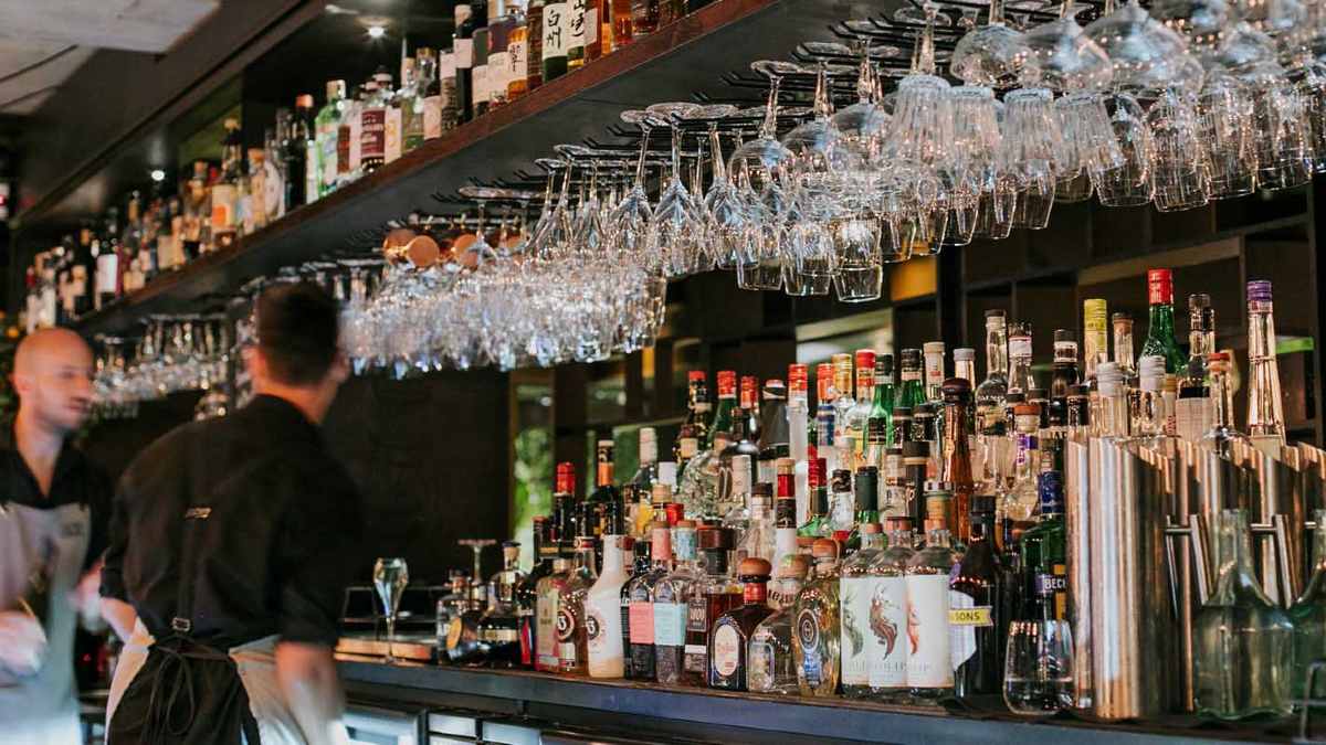 Bartenders cleaning glasses at a bar in Noosa