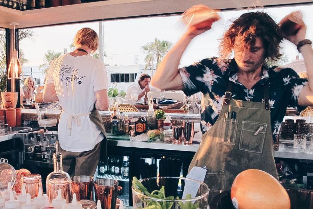 Bartenders shaking cocktails at The Collective in Palm Beach