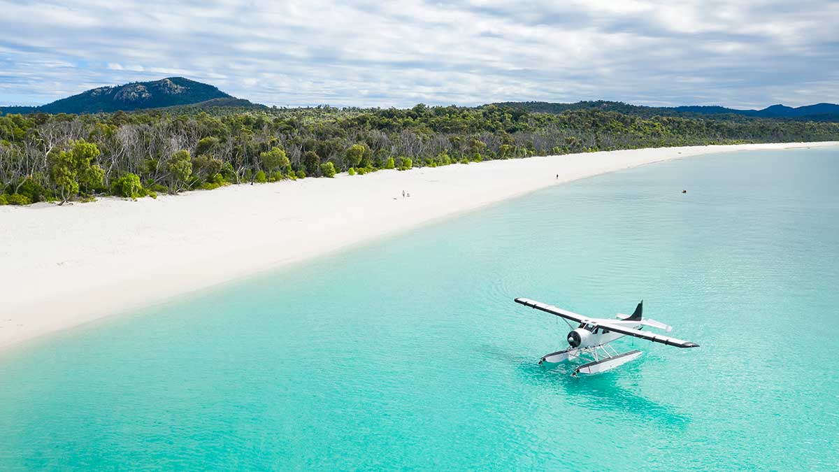 Sea plane landing on clear blue water