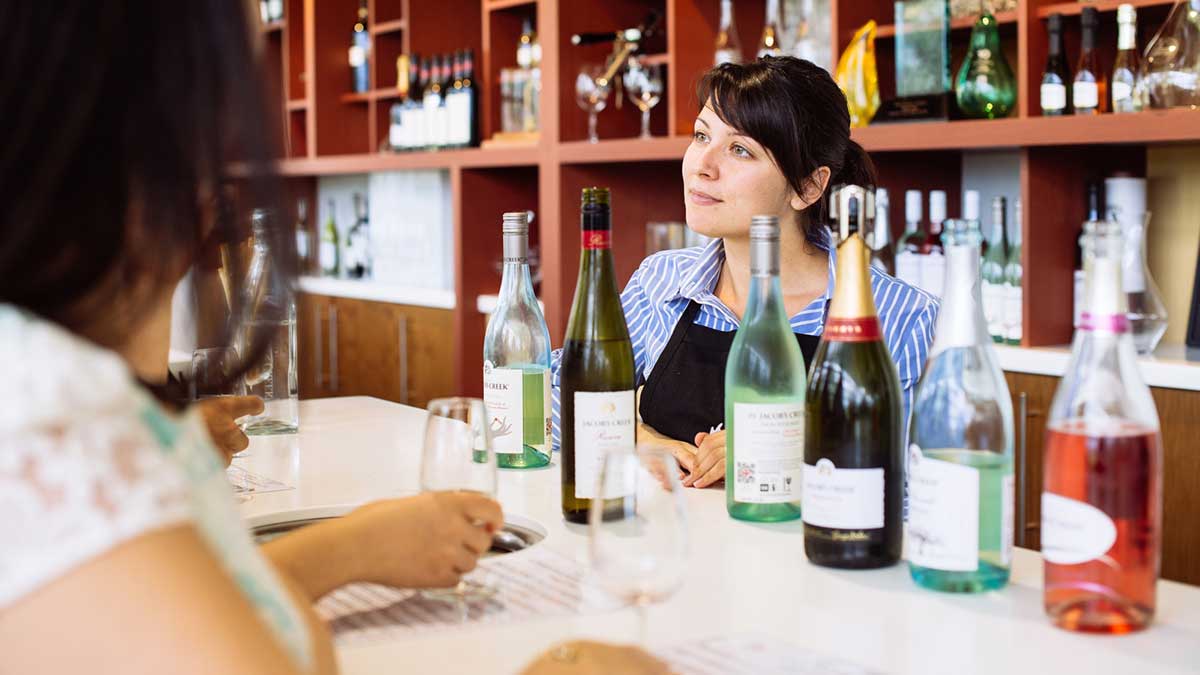 wine bottles lined up on a bar