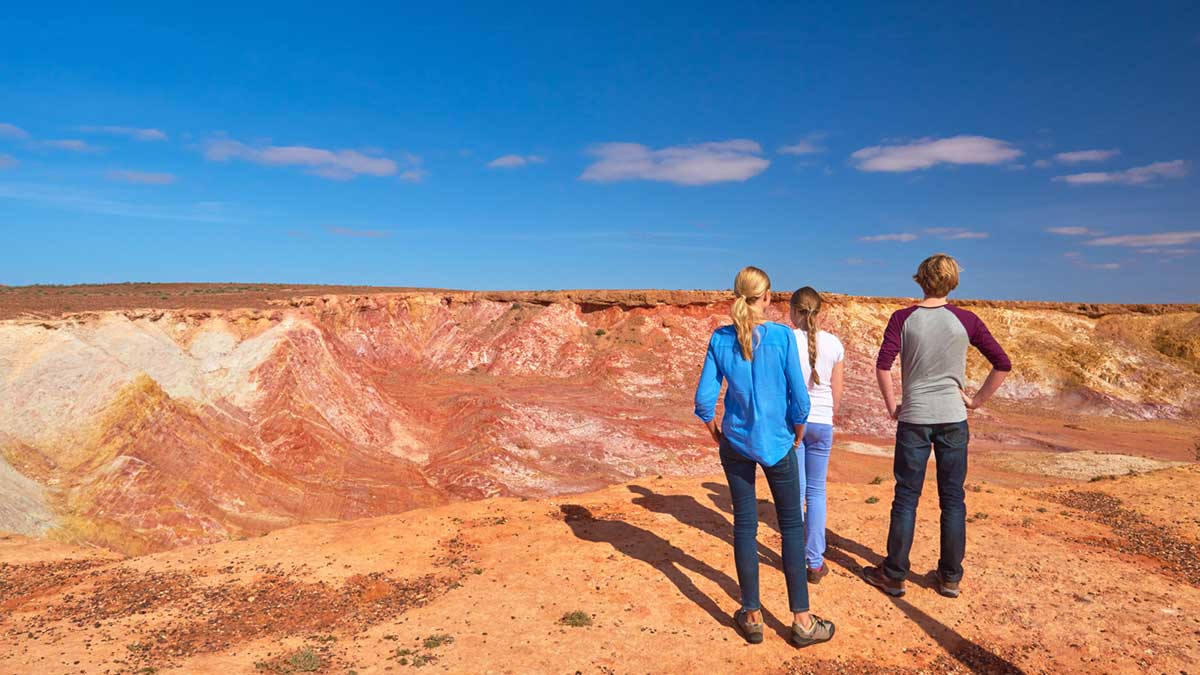 three people standing on top of cliffs in South Australia 