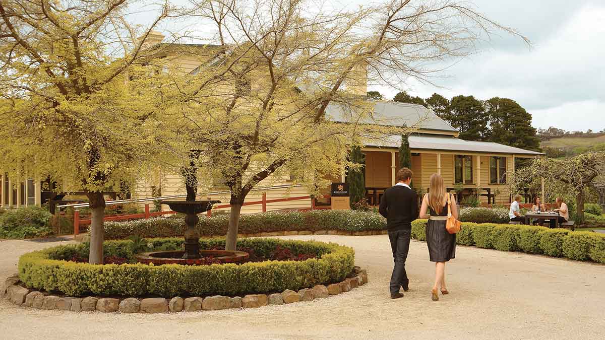 two people walking around a fountain