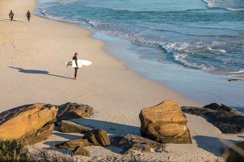 Surfer about to hit the waves in Margaret River, Western Australia