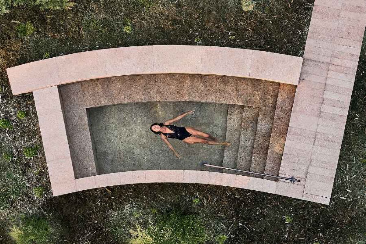 A woman relaxing in a pool at alba thermal springs