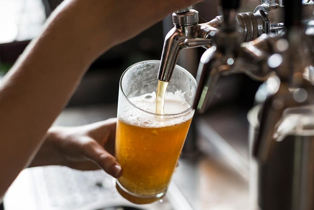 Close up of bartender pouring beer 