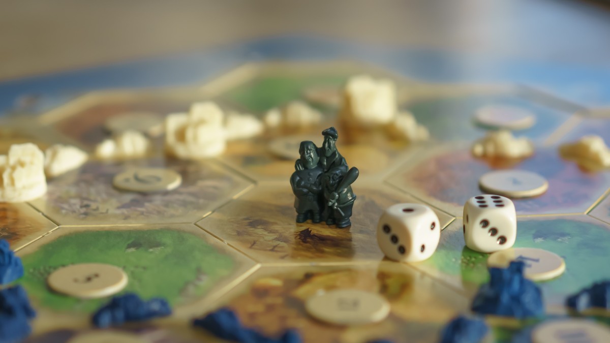 settlers of catan board game being played