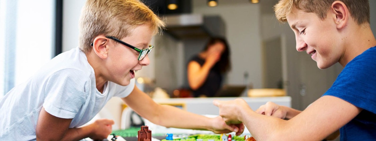 two children playing a board game at home