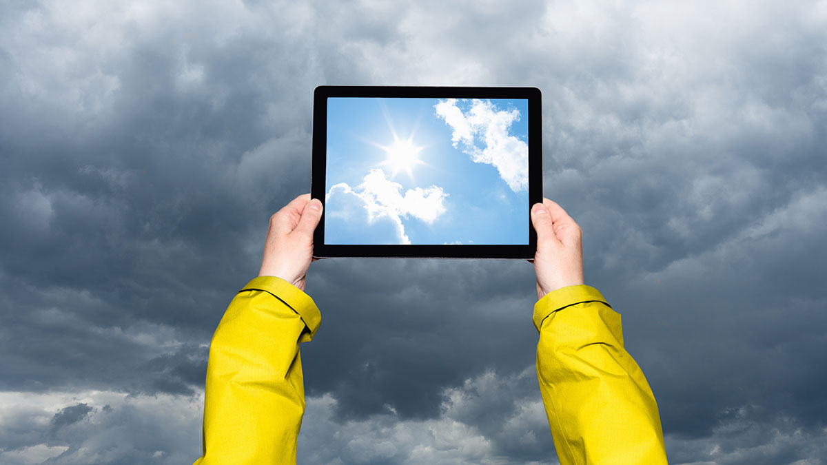 person checking weather for storm on ipad
