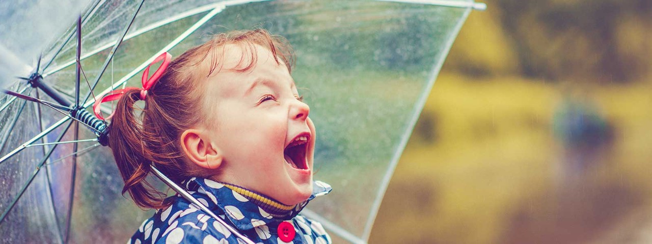 483873618 young girl happy under umbrella