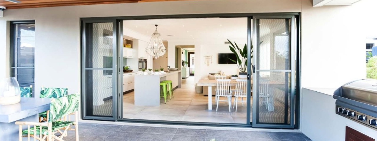 outdoor view of modern kitchen with open sliding doors