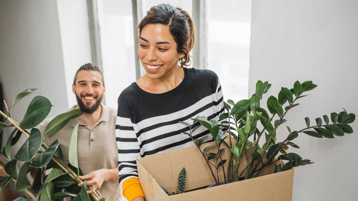 man and woman moving into a new home