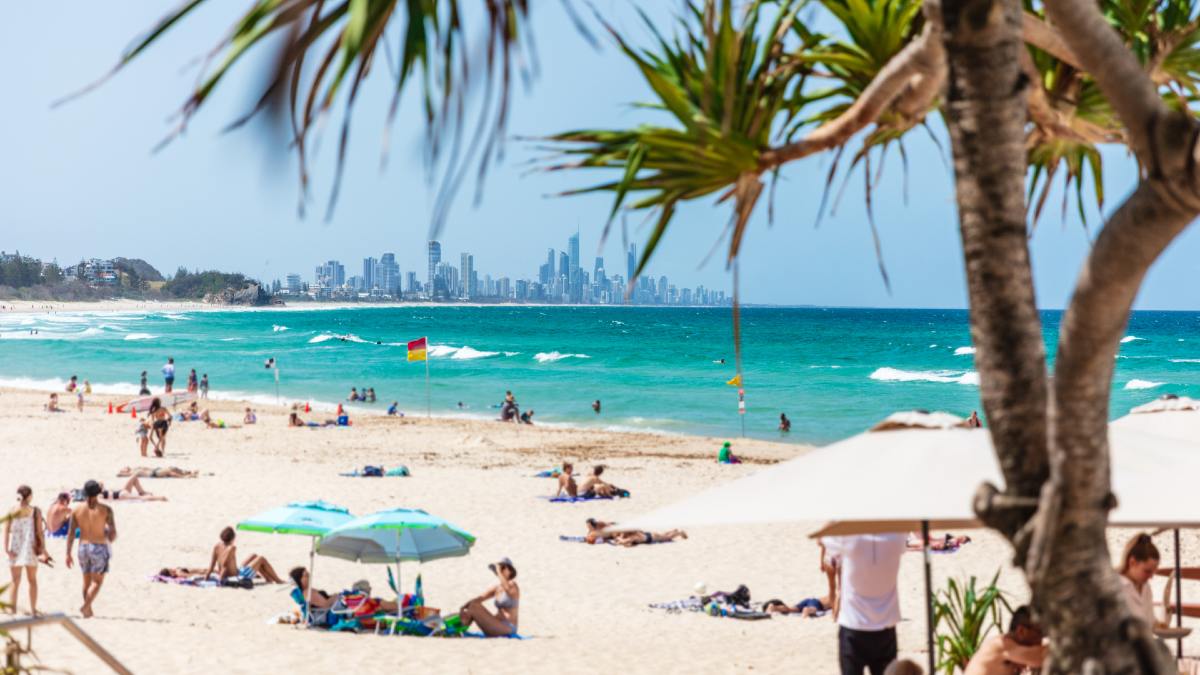 beachgoers at a sandy beach with blue water