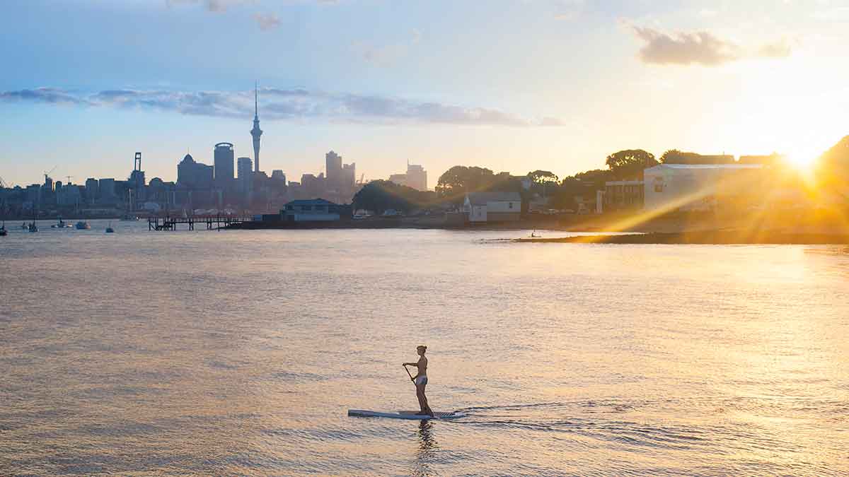 person using a SUP in ocean by Auckland