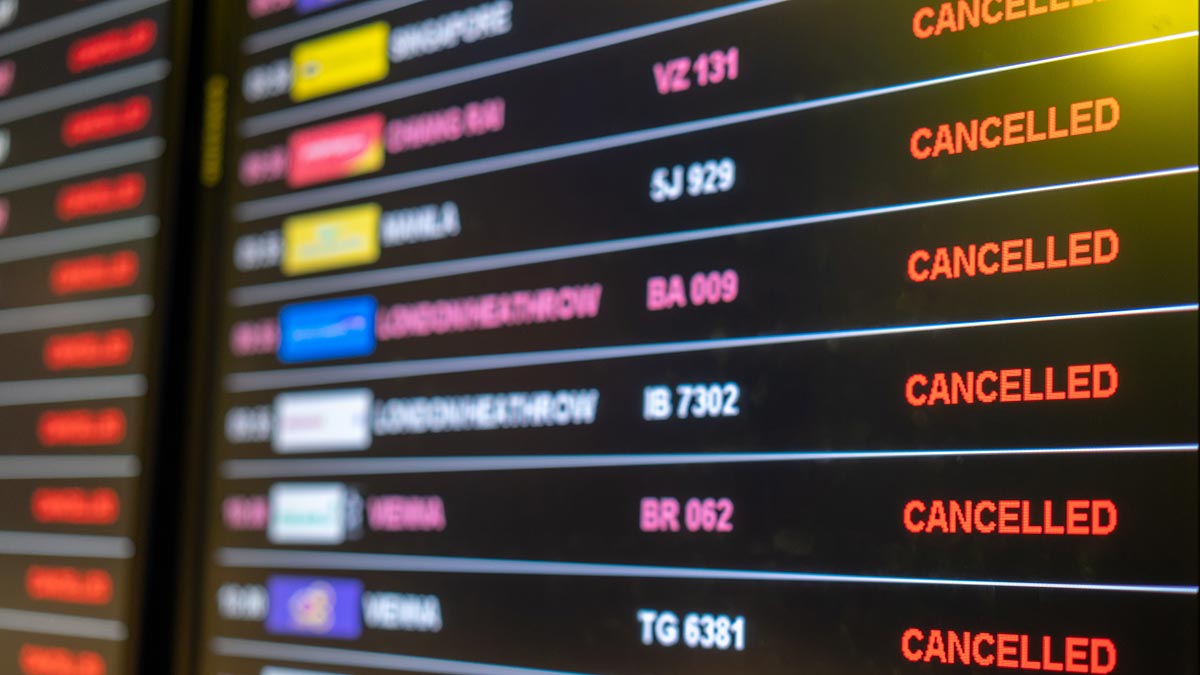 Flight departures board showing cancellations