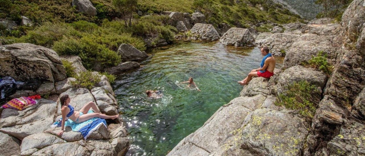 Falls Creek, High Country people swimming and sunbathing in clear swimming hole