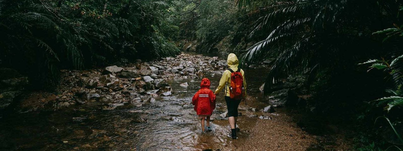 Children hiking in the rain